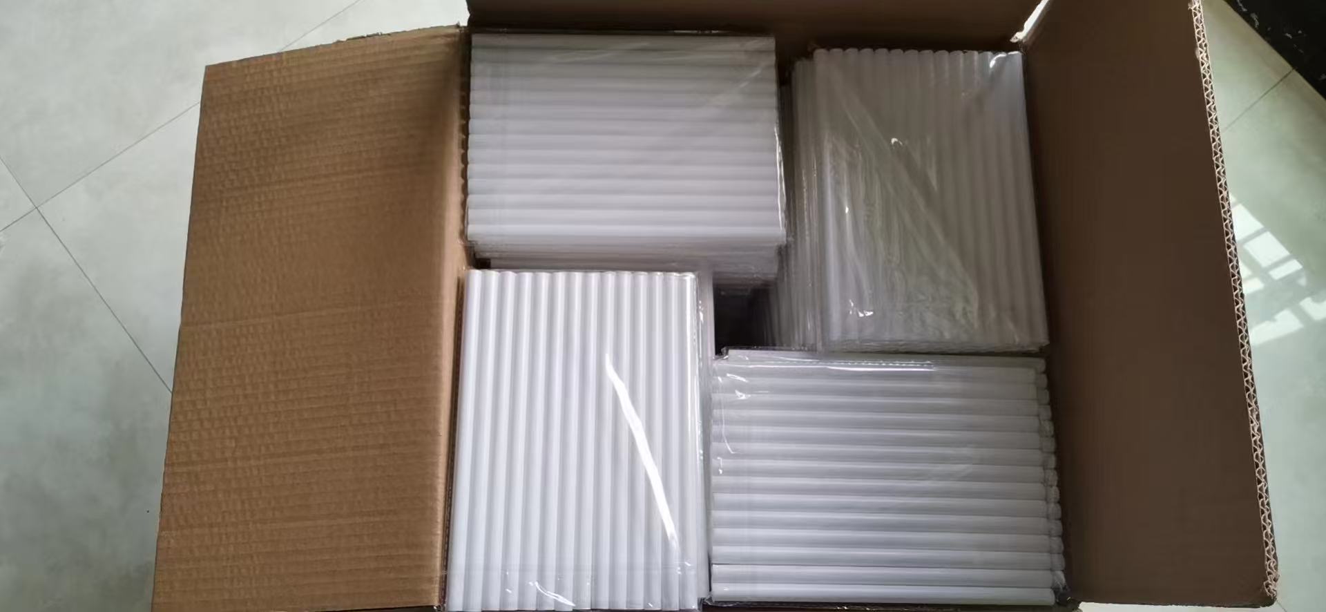 Carton packed with multiple lengths of white cake dowels